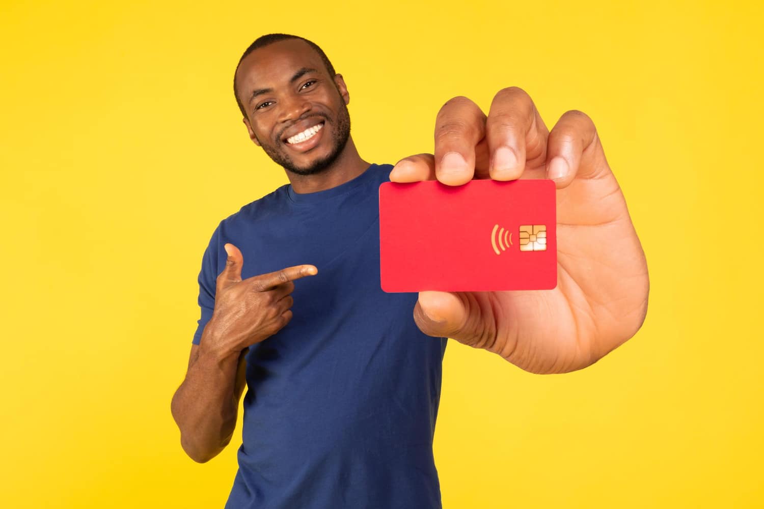 A happy guy holding the Wells Fargo Reflect Card.