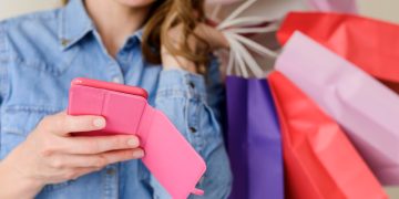 Woman using coupon apps while shopping.