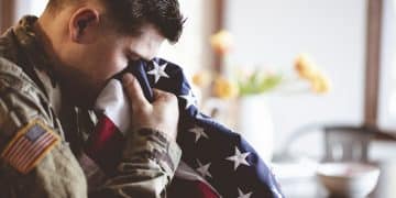 Things to do on Memorial Day: Man kisses the flag of the United States of America