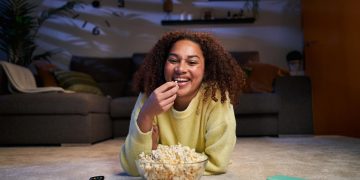 woman enjoying best book to TV adaptations.