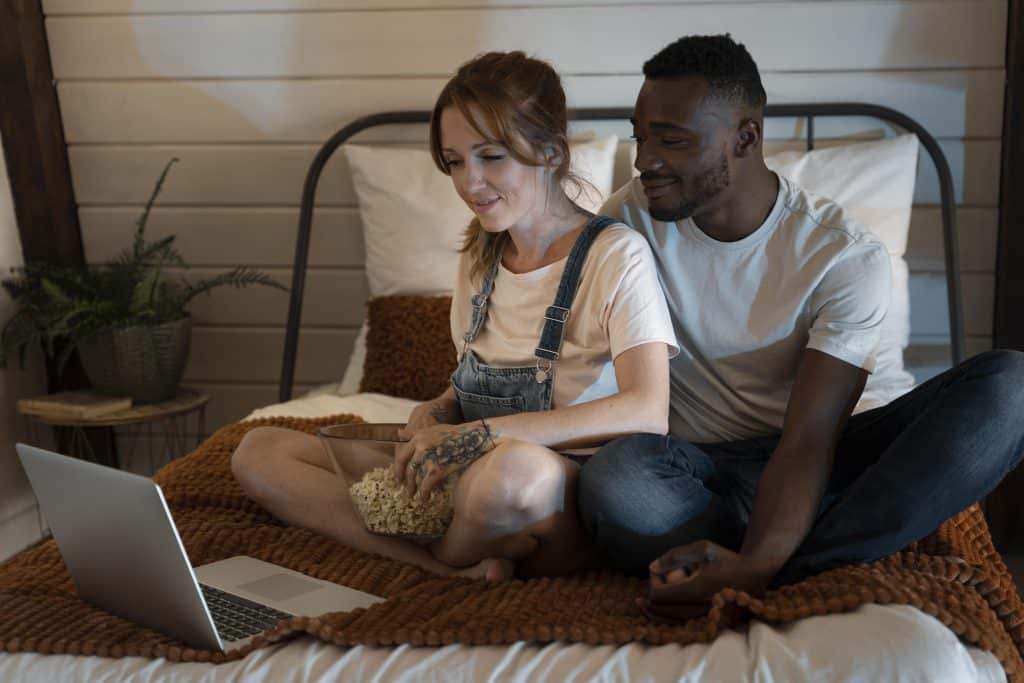 Couple watching a limited series together during a weekend binge